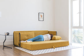 model sleeping on sofa bed in living room scene