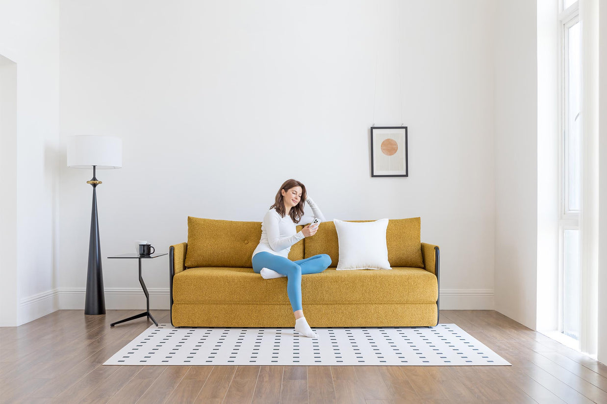 model sitting on sofa bed in living room scene