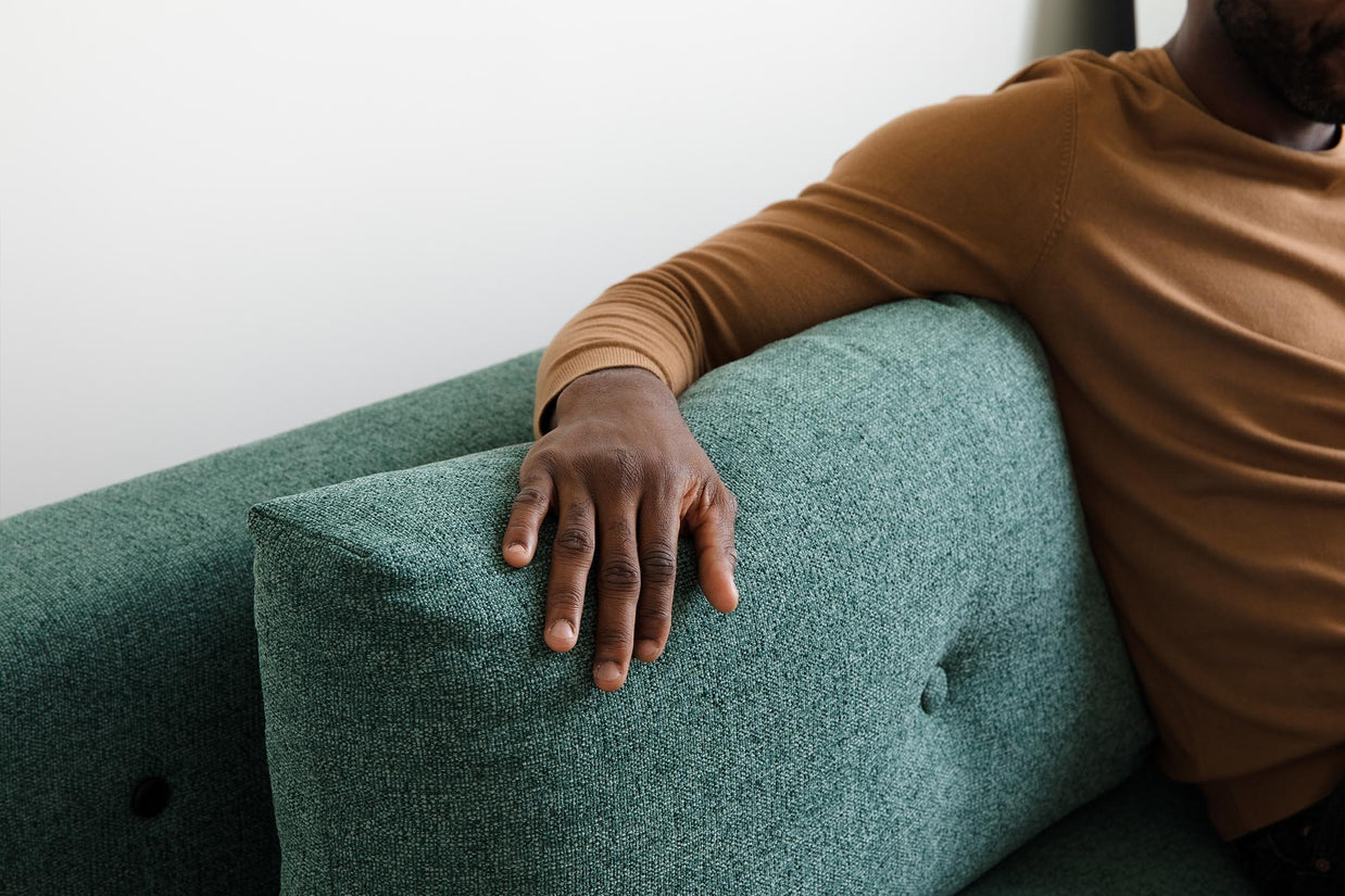 detail of model sitting on sofa bed