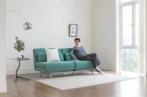 model sitting on sofa bed in living room scene