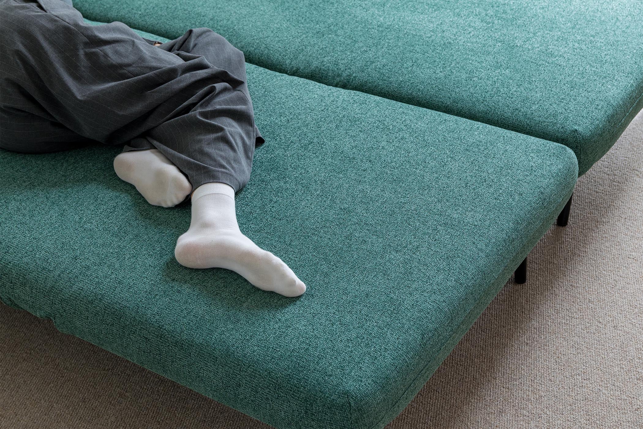 detail of model sleeping on sofa bed