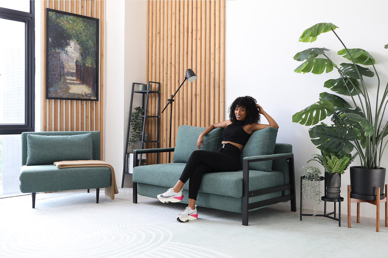 model sitting on sofa bed in living room