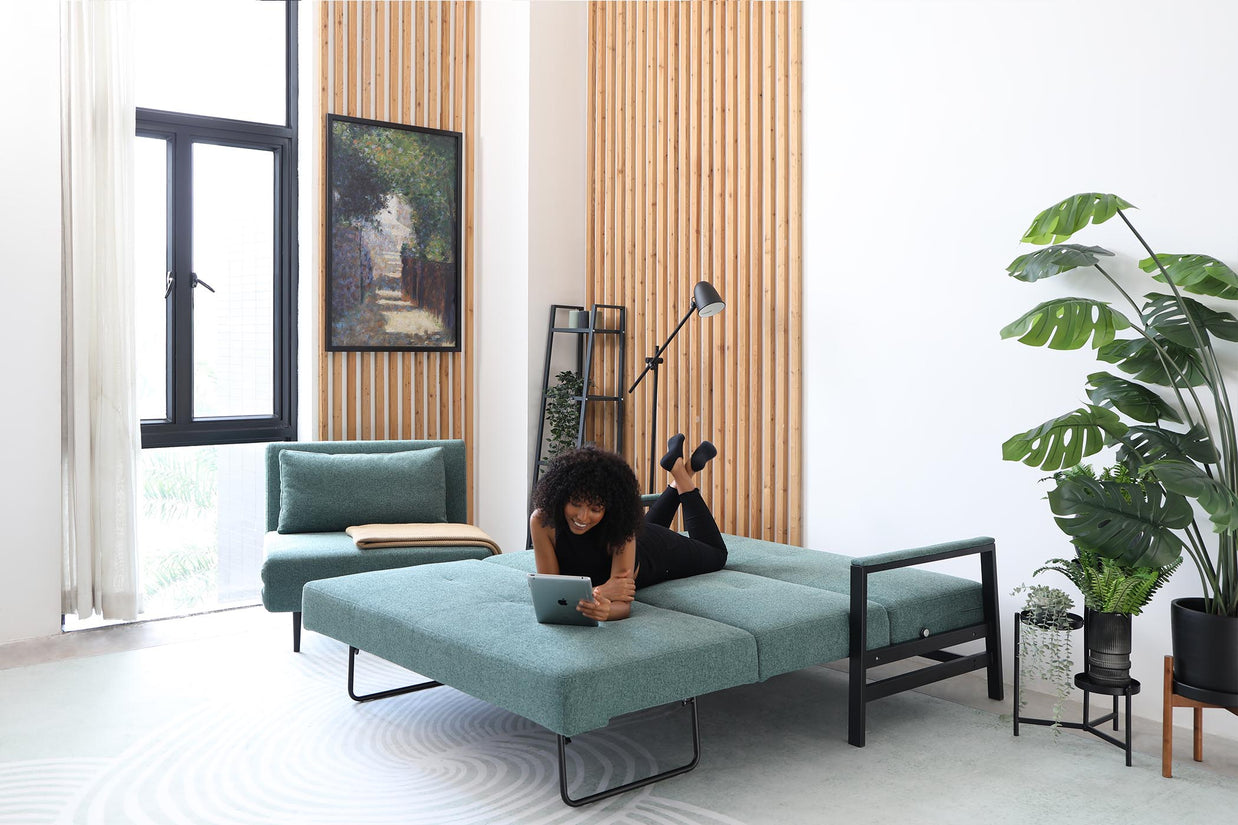 model lying on sofa bed in living room