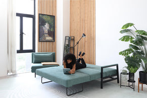 model lying on sofa bed in living room