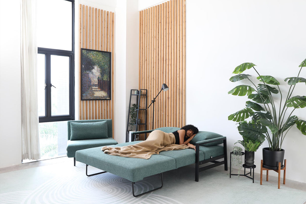 model sleeping on sofa bed in living room