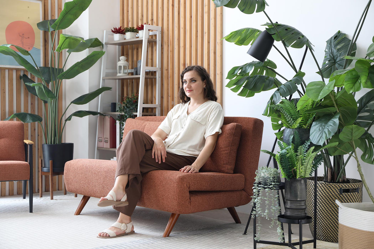 model sitting on sofa bed in living room