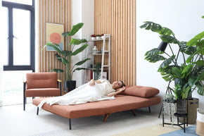 model sleeping on sofa bed in living room
