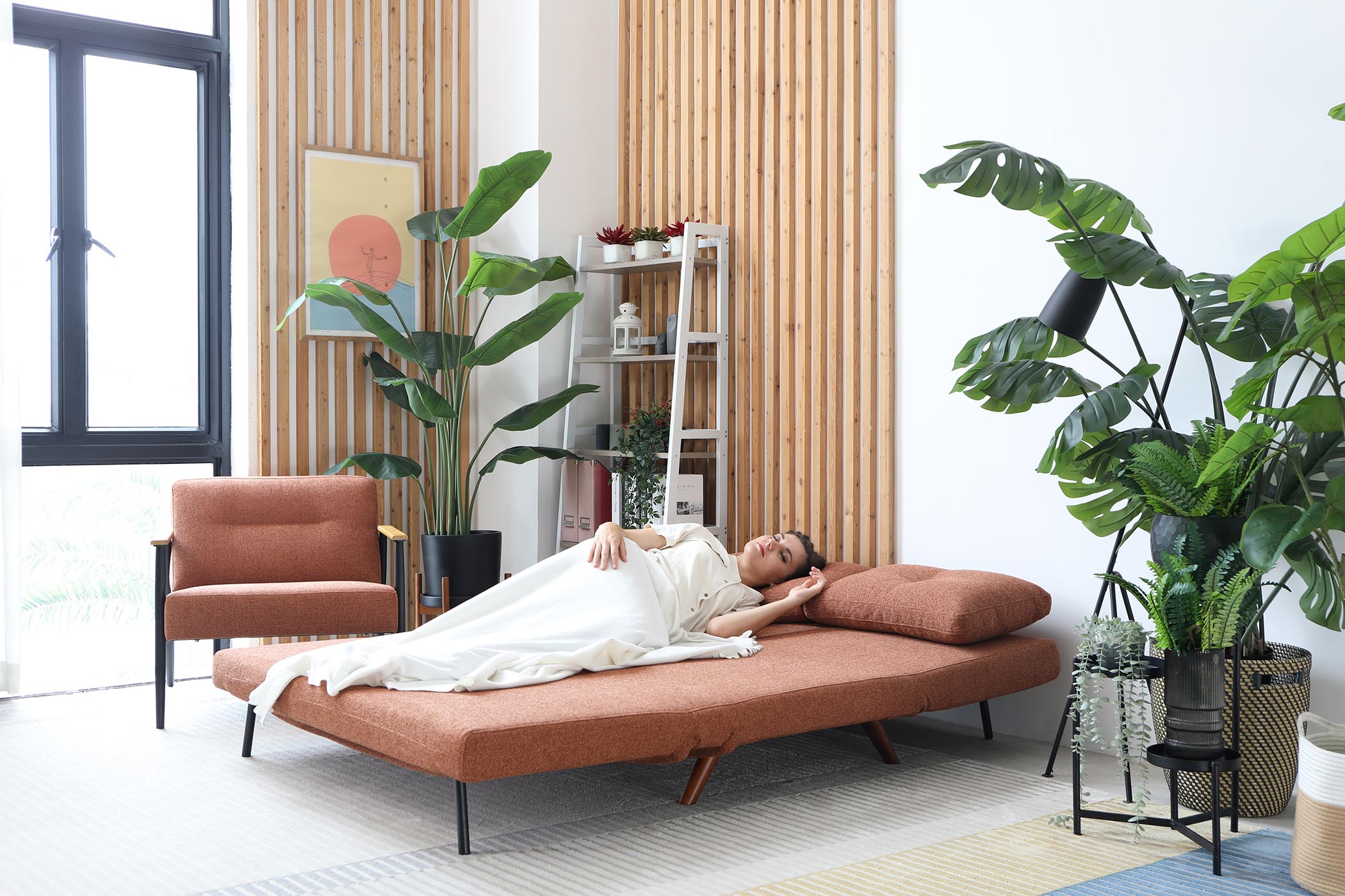 model sleeping on sofa bed in living room