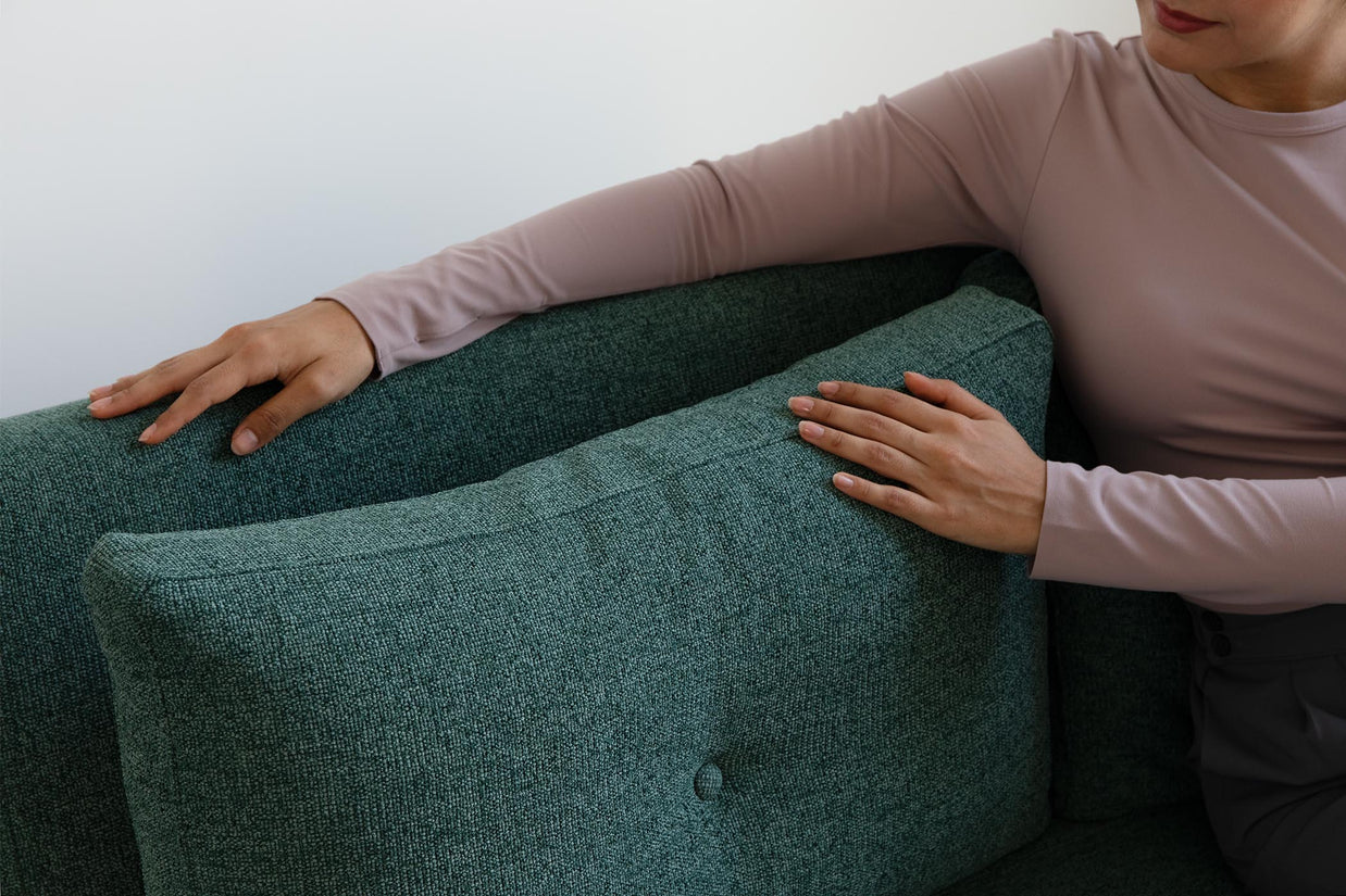 detail of model touching sofa bed