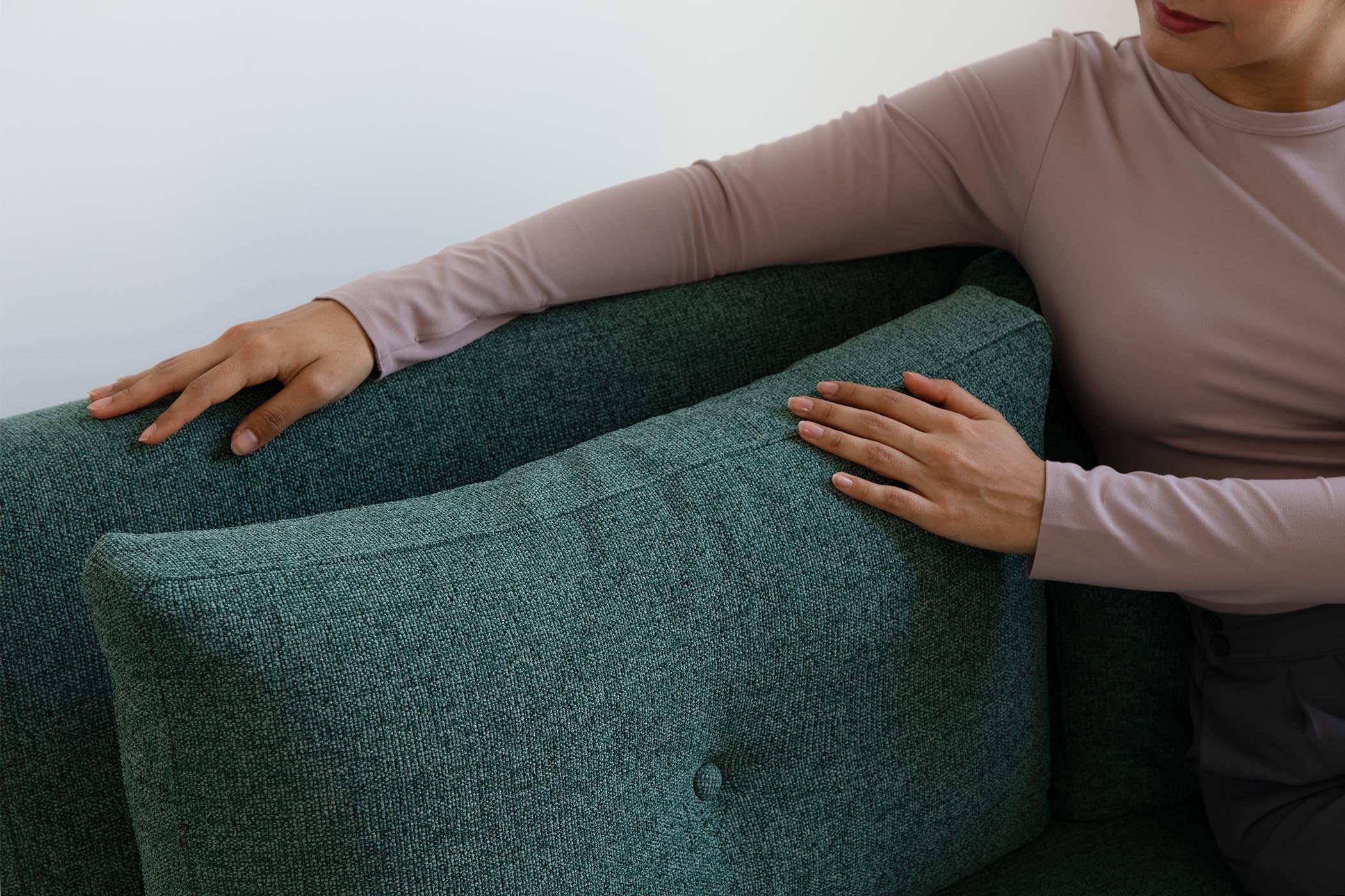 detail of model touching sofa bed